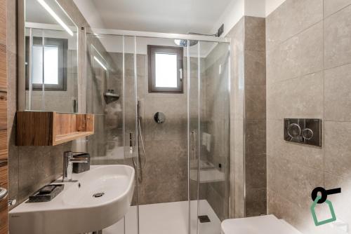 a bathroom with a sink and a shower at Hotiday Apartments La Thuile in La Thuile