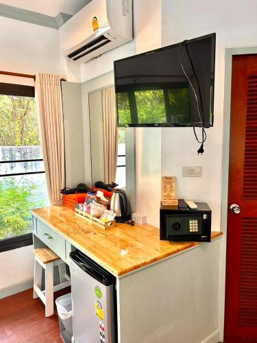a kitchen with a counter top and a microwave at TropiCoco Beach Resort Koh Phangan in Haad Yao