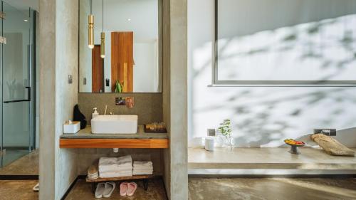 a bathroom with a sink and a mirror at Kong Garden Designer Hotel in Dali Ancient Town