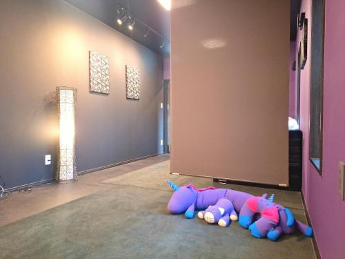 a group of stuffed animals laying on the floor in a room at ペットも泊まれる小さなお宿虎凜Korin in Nagoya
