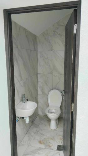 a bathroom with a toilet and a sink at Dar Jamila - Au coeur de l'Oasis - in Gabès