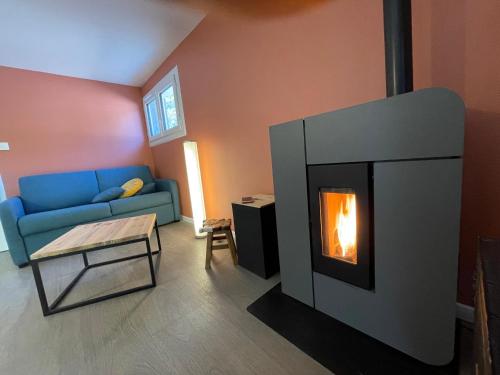 a living room with a fireplace and a couch at MARGUERITE GAP Jardin Piscine chauffée in Gap