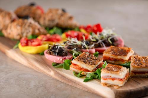 a plate of food with a salad on a table at AC Hotel by Marriott Clodio Roma in Rome
