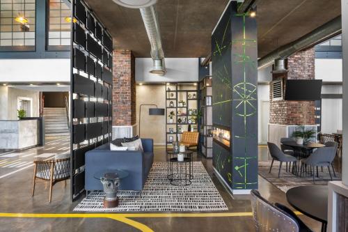 a lobby of a restaurant with chairs and tables at Protea Hotel by Marriott O R Tambo Airport in Kempton Park