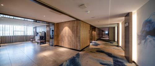 a hallway in a building with a painting on the wall at Mehood Lestie, Zhangbaliu Road, Xi'an High-tech Zone in Chang'an