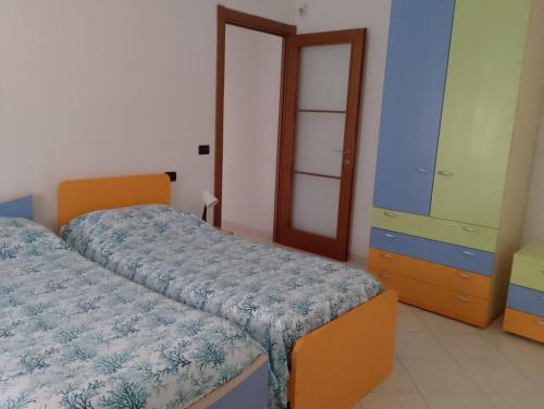 a bedroom with two beds and a dresser at Casa Stella in Savona