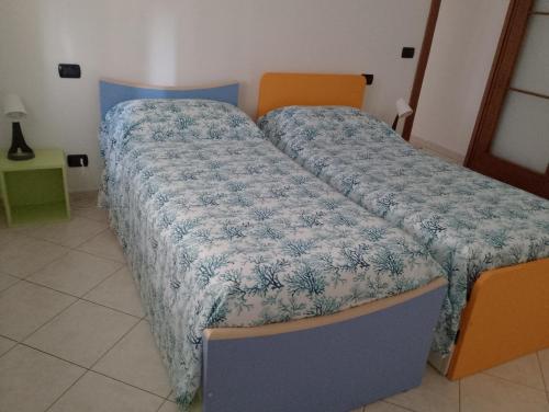a bedroom with two beds with covers on them at Casa Stella in Savona