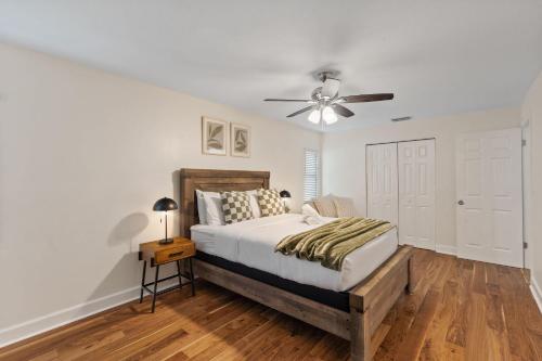 a bedroom with a bed and a ceiling fan at Sunshine State Retreat Luxury Pool Home in Brandon