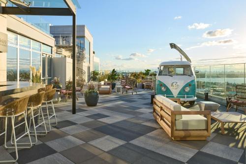 a rooftop patio with tables and chairs on a building at Renaissance New York Flushing Hotel at Tangram in Queens