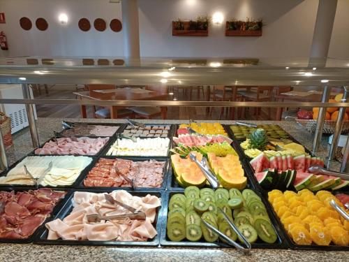 a buffet of different types of food on display at Marina Tossa in Tossa de Mar
