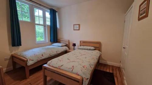 Postel nebo postele na pokoji v ubytování Siskin Cottage