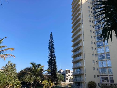 a tall building with a tree on top of it at La Ballito Beachfront Breakaway in Ballito