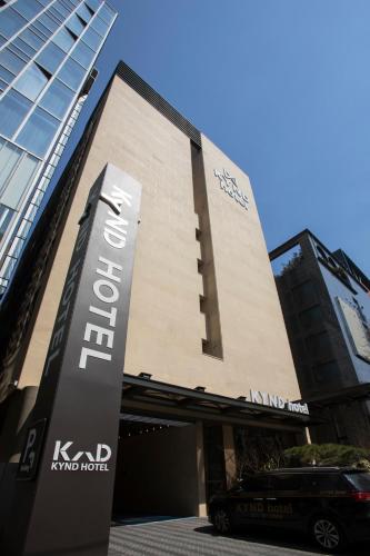 a building with a sign in front of it at Pangyo Business & Tourist Hotel KYND in Seongnam