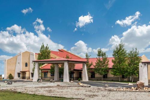 a large building with a red roof and a building at Comfort Inn & Suites Alamosa in Alamosa