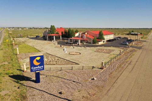 a sign for a car dealership next to a road at Comfort Inn & Suites Alamosa in Alamosa