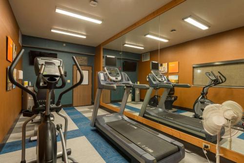 a gym with two tread machines and a mirror at Comfort Inn & Suites Alamosa in Alamosa