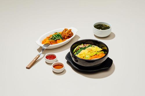 a table with a bowl of food and a bowl of food at Four Points by Sheraton Josun, Seoul Station in Seoul