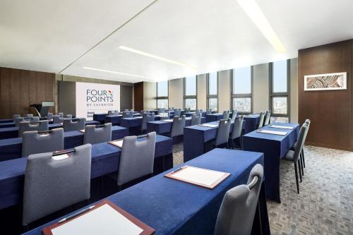 a conference room with blue tables and chairs at Four Points by Sheraton Josun, Seoul Station in Seoul