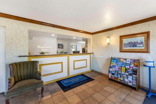 a waiting room with a chair and a counter at Rodeway Inn at Nevada State Capitol in Carson City