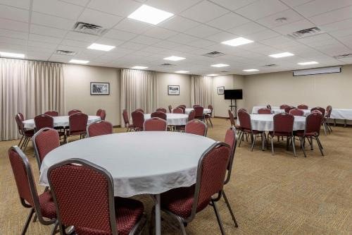 a conference room with tables and chairs and a podium at MainStay Suites Bowling Green North in Bowling Green