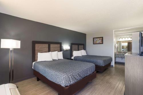 a hotel room with two beds and a kitchen at Econo Lodge Cave City in Cave City