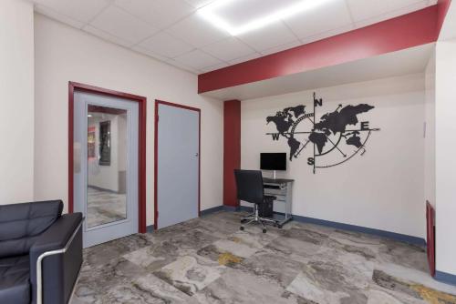 an office with a desk and a computer on a wall at Econo Lodge Cave City in Cave City