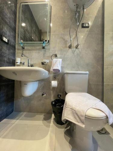 a bathroom with a white toilet and a sink at Unique Pyramids Boutique INN in Cairo