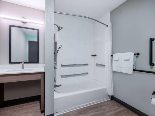 a bathroom with a shower and a sink at ECHO Suites Extended Stay by Wyndham Spartanburg in Spartanburg
