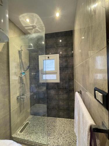 a bathroom with a shower with a glass door at Unique Pyramids Boutique INN in Cairo