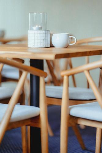 a table with a cup and a candle on it at Strandidyl Bed and Breakfast in Haderslev