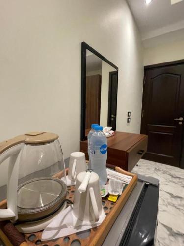 a kitchen counter with a sink and a mirror at Unique Pyramids Boutique INN in Cairo
