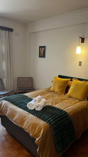 a bedroom with a large bed with towels on it at Retro City Center Gem by ARPA Hospitalities in Stellenbosch