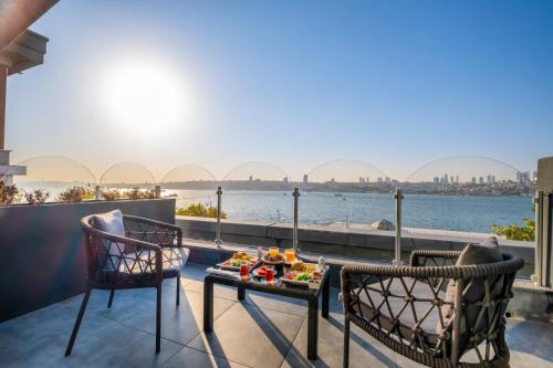 a balcony with two chairs and a table with food on it at 216 Bosphorus in Istanbul