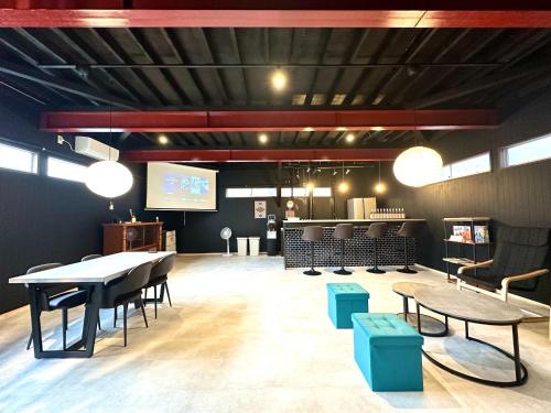 a dining room with tables and chairs and a screen at Machiyado Niko - Vacation STAY 83480v in Kusatsu