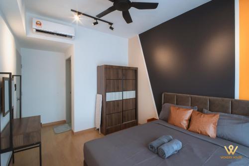 a bedroom with a bed and a ceiling fan at Mayabay Gamuda Cove SplashMania Suite in Banting