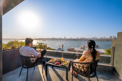 a man and a woman sitting at a table with food at 216 Bosphorus in Istanbul