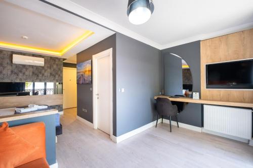 a living room with a desk and a tv on the wall at 216 Bosphorus in Istanbul