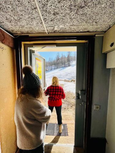 two women are looking out of a train door at Studio station Puy-Saint-Vincent 1700 in Puy-Saint-Vincent