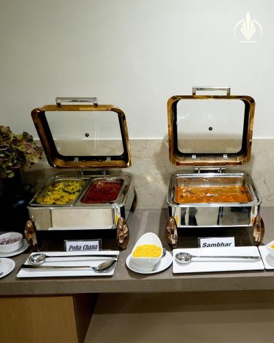 two trays of food sitting on top of a counter at SIVANTA by BOMBAY GROUP OF HOTELS NAGPUR in Nagpur
