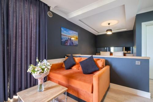 a living room with an orange couch and a table at 216 Bosphorus in Istanbul