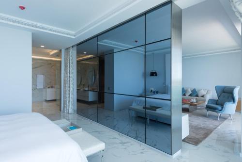 a bedroom with glass walls and a bed at Marchica Lagoon Resort in Nador