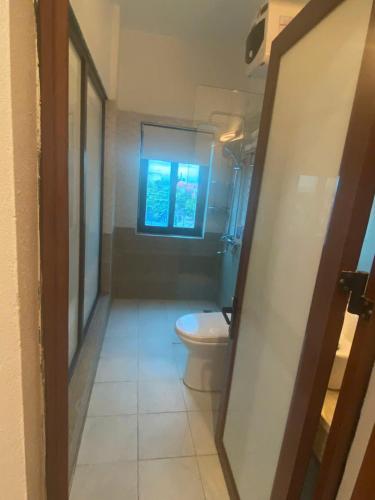 a bathroom with a toilet and a window at Luxury Airport Hotel - Convenient & Friendly in Hanoi