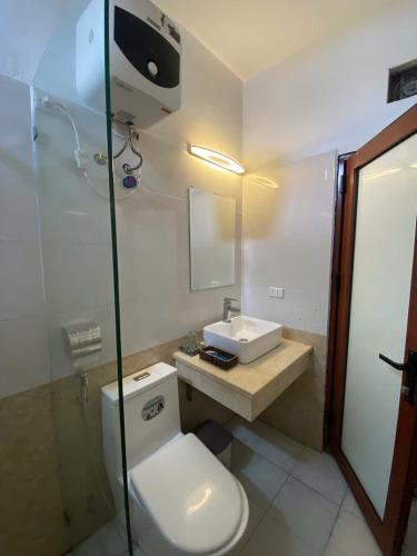 a bathroom with a toilet and a sink and a shower at Luxury Airport Hotel - Convenient & Friendly in Hanoi