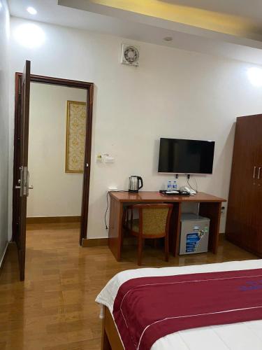 a bedroom with a desk and a tv and a bed at Luxury Airport Hotel - Convenient & Friendly in Hanoi