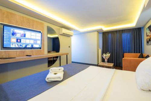 a hotel room with a bed and a flat screen tv at 216 Bosphorus in Istanbul