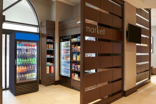 a grocery store aisle with a refrigerator and a soda machine at Residence Inn by Marriott London Canada in London