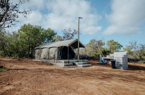 a tent is set up on a dirt field at Peace Haven @ Windfarm Accommodation in Yzerfontein