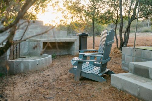 two green chairs sitting in front of a concrete bench at Peace Haven @ Windfarm Accommodation in Yzerfontein