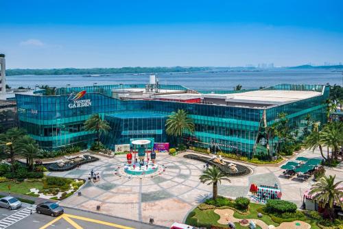 an overhead view of a large glass building with a parking lot at Cozy Beachfront Seaview with 2 CarParks FOC Netflix Access and YouTube Premium 3Beds3Bath 6-11pax by Minshuku in Johor Bahru