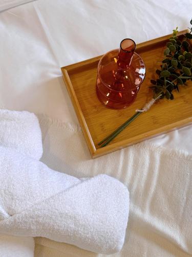 a wooden tray with a vase and a candle at Cozy Beachfront Seaview with 2 CarParks FOC Netflix Access and YouTube Premium 3Beds3Bath 6-11pax by Minshuku in Johor Bahru